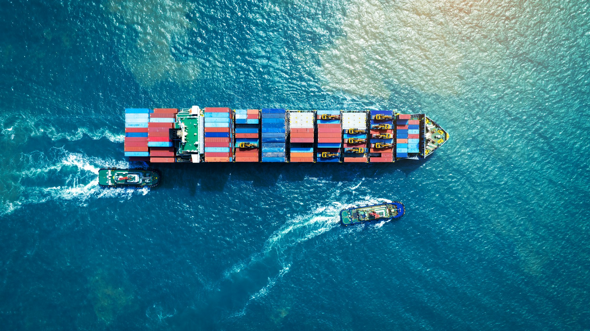 Cargo Container Ship running with with Tugboat. container ship import export